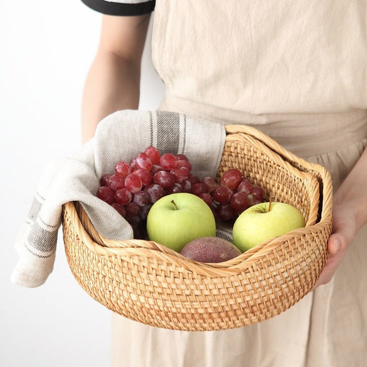 Three natural beige wicker baskets with braided rims, intricately woven and nested, ideal for storage, decor, or organization